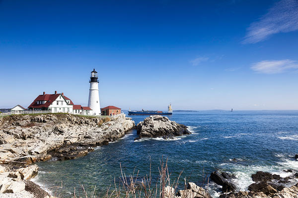 Lighthouse on a rocky coast at sea